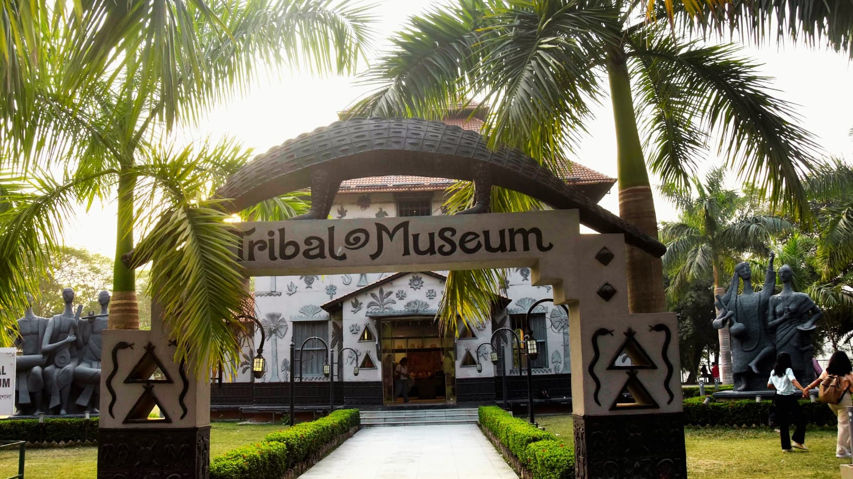 <p>The entrance to the Tribal Museum, with its striking animal motifs and Santiniketan-inspired design.</p>
