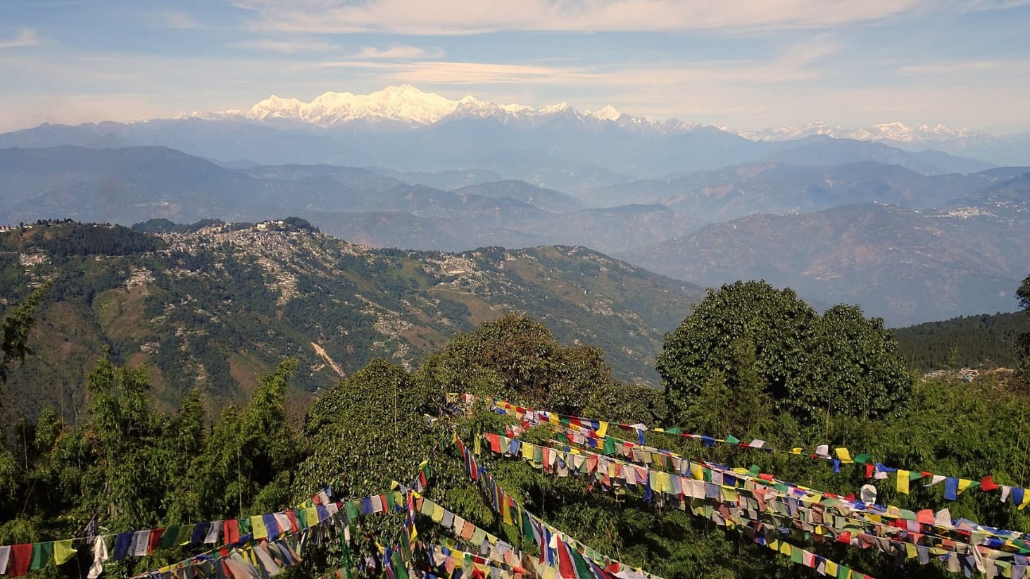 <p>Prayer flags line the sweeping views from Tiger Hill. (Picture by DaLoetz, Wikimedia Commons)</p>