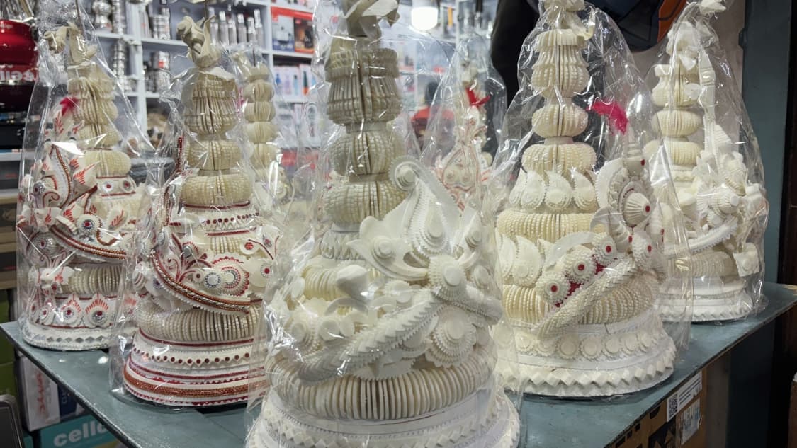 <p>A row of traditional topors — intricate, white sholapith (pith foam) crowns are traditionally worn by grooms in Bengali weddings.</p>