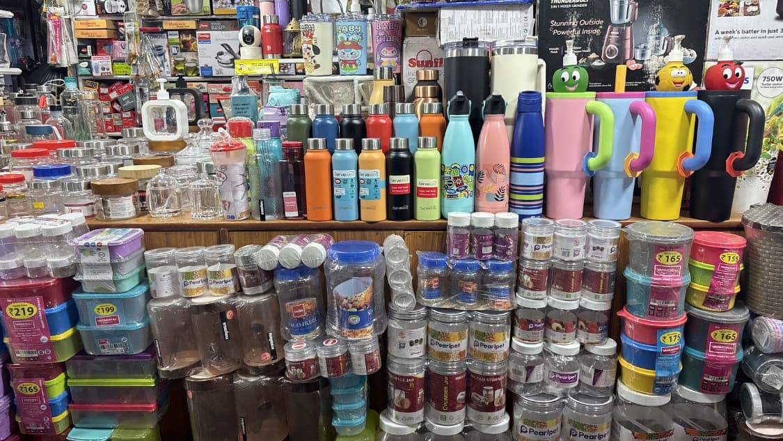 <p>Colourful tumblers and different kinds of storage boxes are on display.</p>