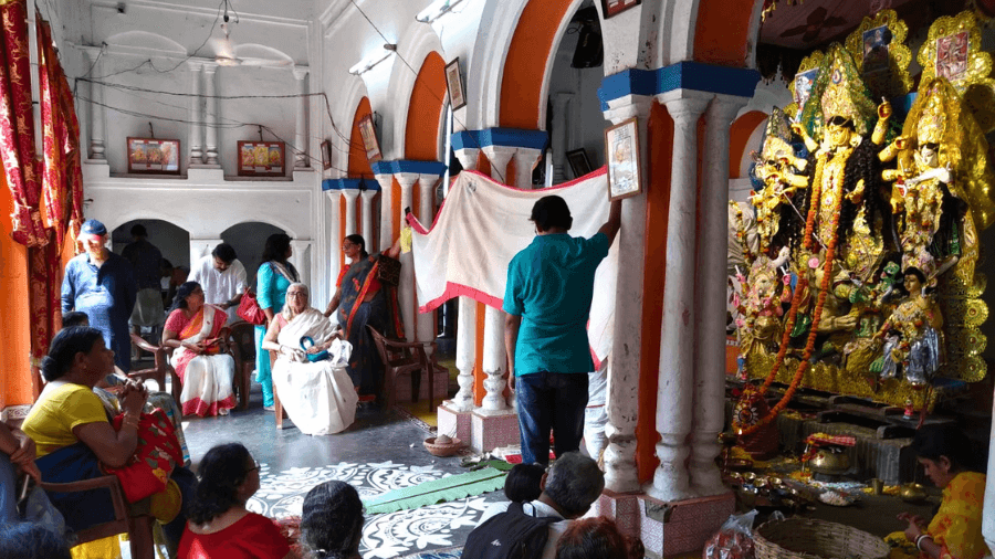 <p>Family members attending the puja held at the Durga dalan of the Dutta Chowdhury ancestral home. (Picture by Amitabha Gupta)</p>